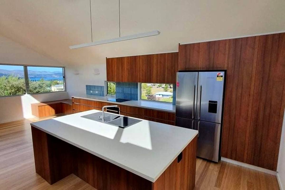 Moonah alterations and additions, timber kitchen with white stone island and river views, built by LHPL Contracting