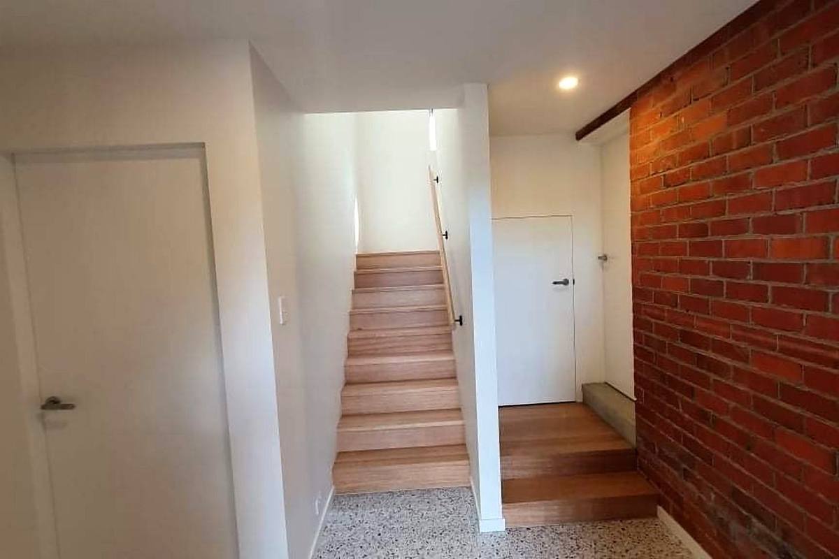 Moonah alterations and additions, timber stair beside exposed brick wall, built by LHPL Contracting