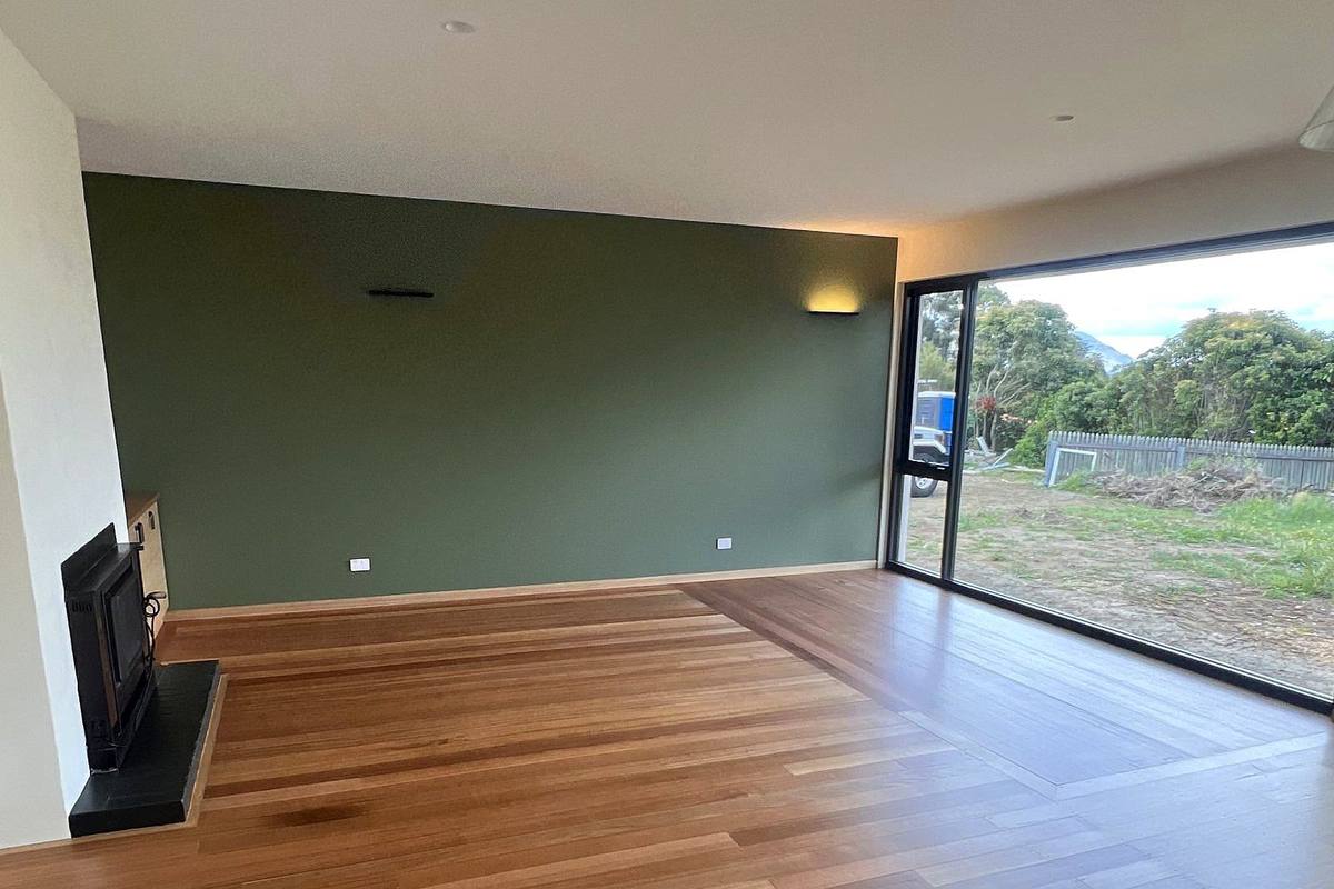 Richmond alterations and additions, living room with wood heater and sliding doors, built by LHPL Contracting